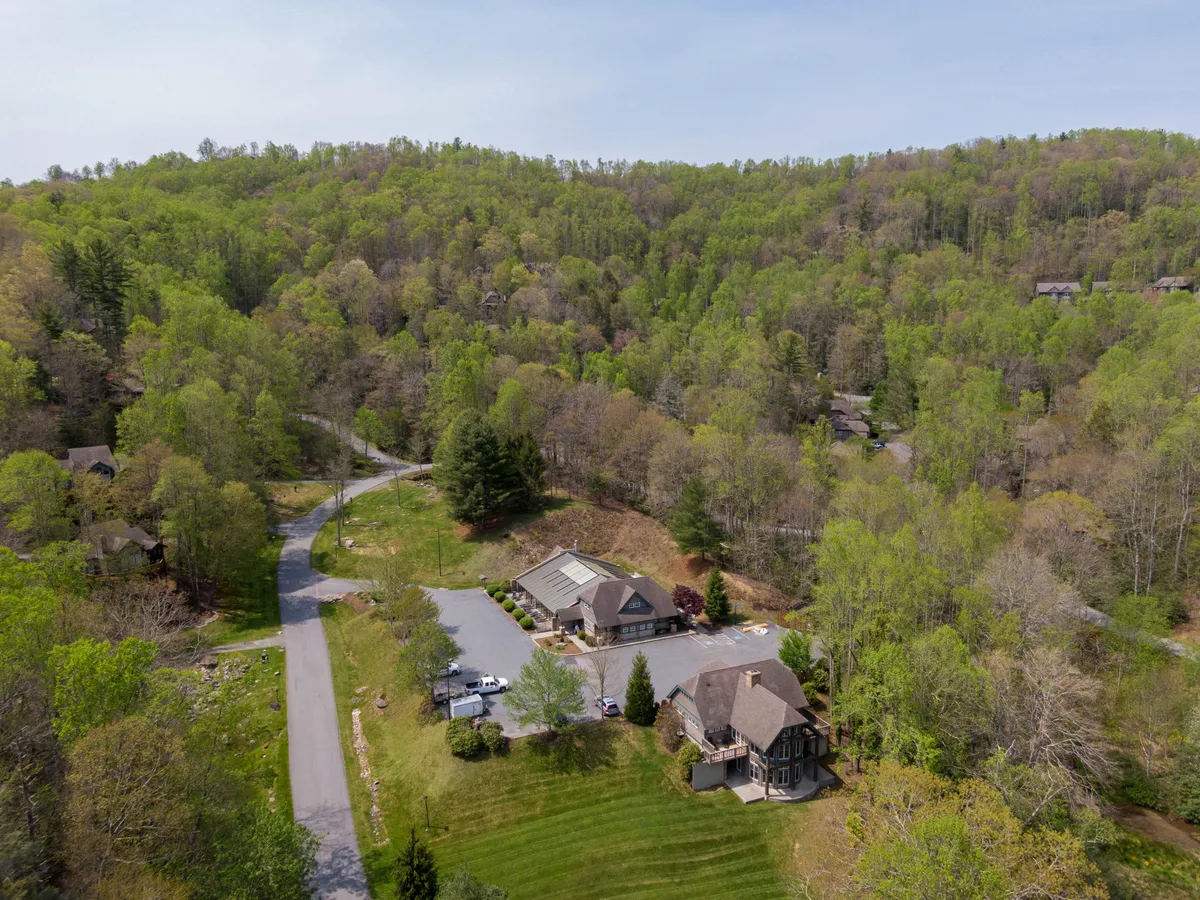 This exterior shot captures the main building of Bearfoot Lodge nestled among greenery, with a winding road leading up to it. The image conveys the sense of arrival, privacy, and scenic beauty, emphasizing the lodge’s setting as a base for exploration.